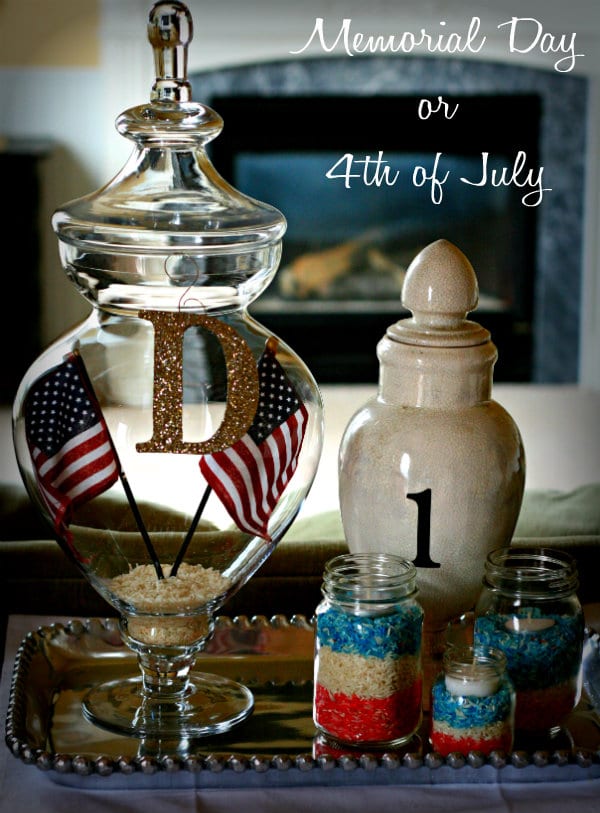 Patriotic Decorating vignette with mason jars filled with layered red, white and blue colored rice. 