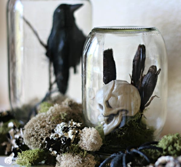 Halloween crows and skeletons inside a glass jar