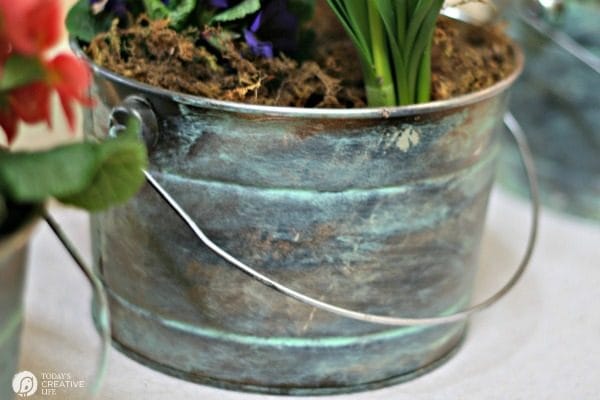 DIY Faux Patina | Distressed Aged Metal Patina bucket with a plant inside. 