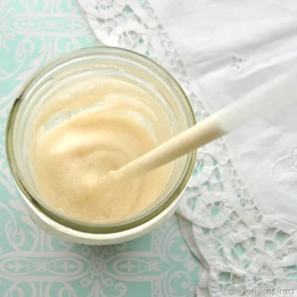 Looking down on a Frappuccino Recipe in a mason jar. White frothy drink.