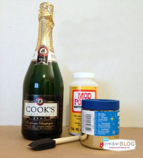 How to Make Glittered Champagne Bottles | Make this easy New Years Eve or Wedding decor with this simple tutorial. See more on TodaysCreativeLife.com