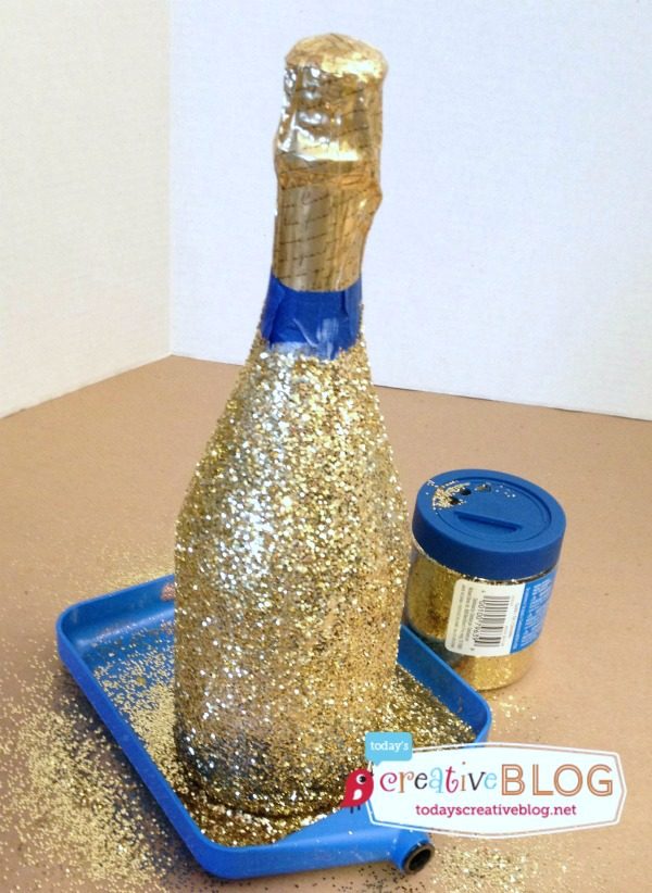 How to Make Glittered Champagne Bottles | Make this easy New Years Eve or Wedding decor with this simple tutorial. See more on TodaysCreativeLife.com