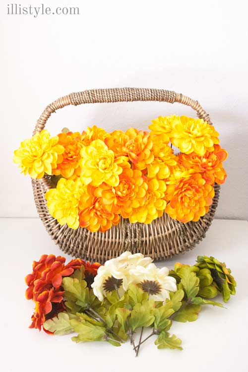 front door fall decor ideas | basket with faux flowers in fall colors in a basket