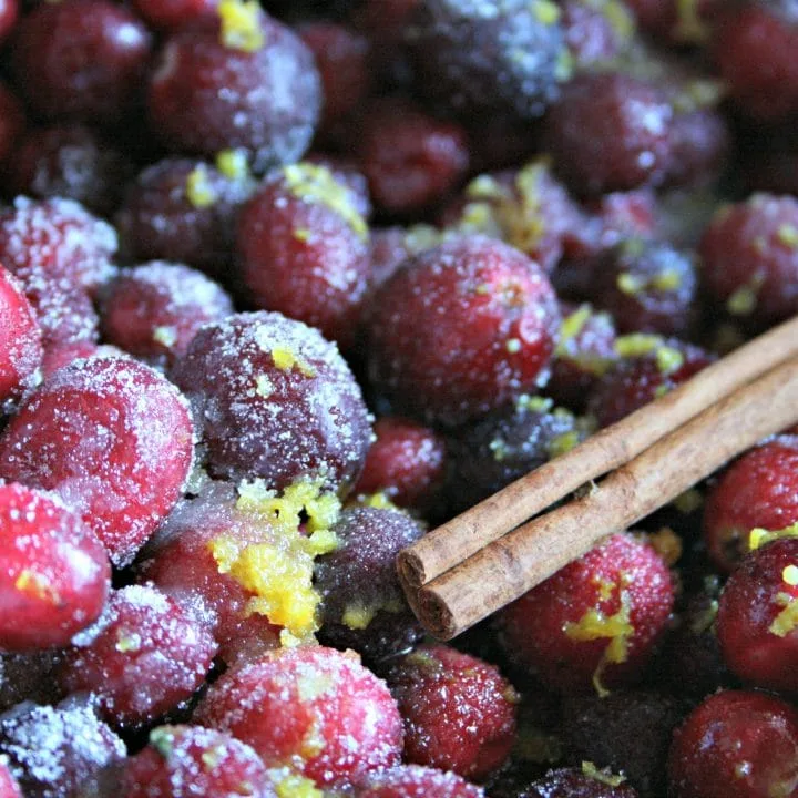 cranberries, cinnamon sticks, and orange zest in a slow cooker to make crockpot cranberry orange sauce