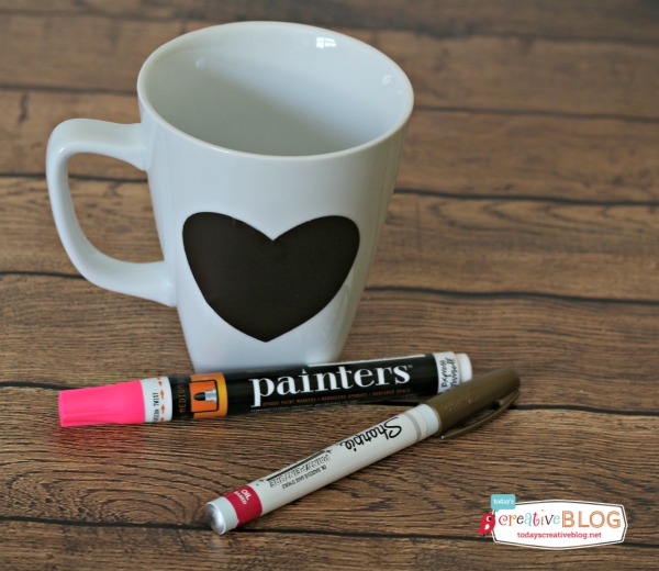 White Mug with black heart sticker to be painted with paint pens.