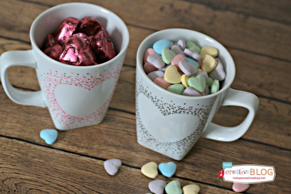 DIY Confetti Painted Heart Mugs | two white mugs filled with candy.