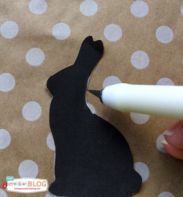 Craft knife cutting bunny silhouette from paper