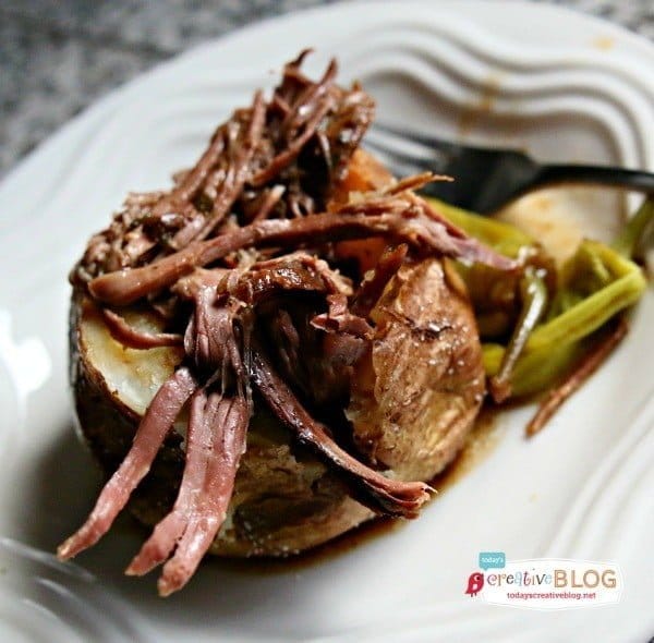 shredded Mississippi roast served over a baked potato