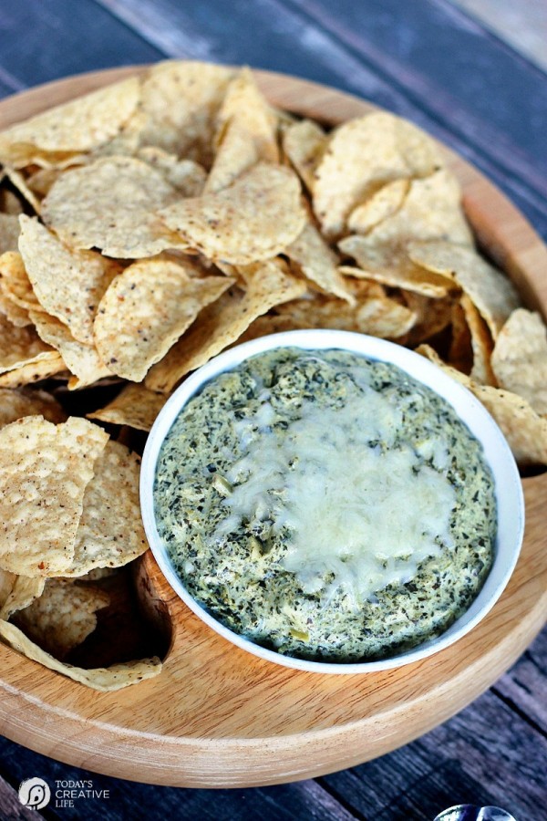 hot cheesy spinach artichoke dip with a side of corn tortilla chips