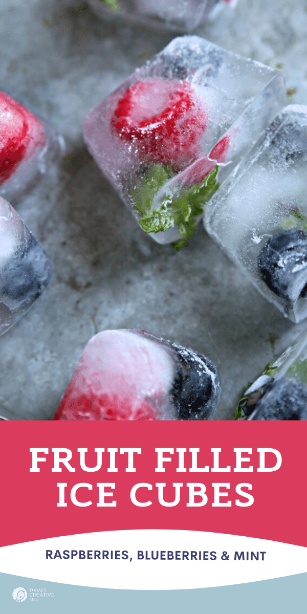 Fruit filled ice cubes with raspberries and mint