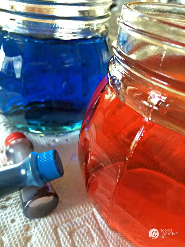 Red and blue water in glass jars