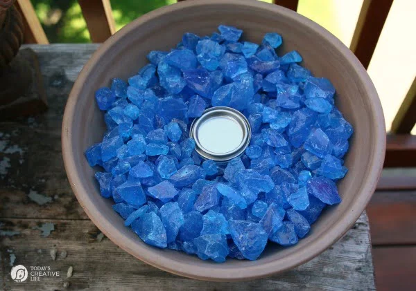 large flower pot filled with blue fire glass