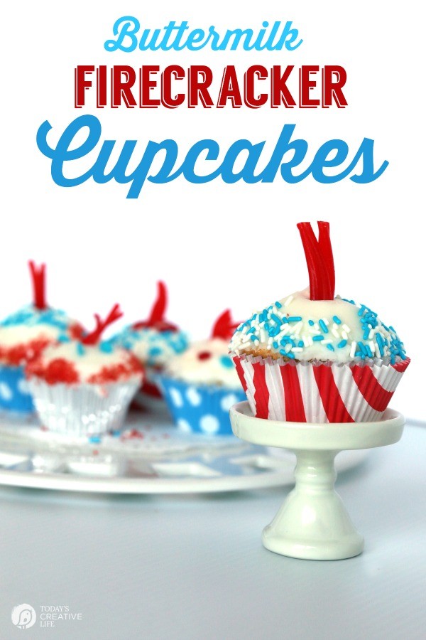 Buttermilk Firecracker Cupcakes decorated with blue and white sprinkles, with red licorice sprouting from the middle like a firework. 