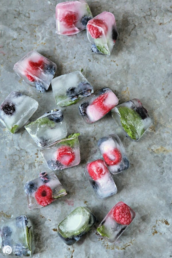 fruit filled ice cubes on a metal tray