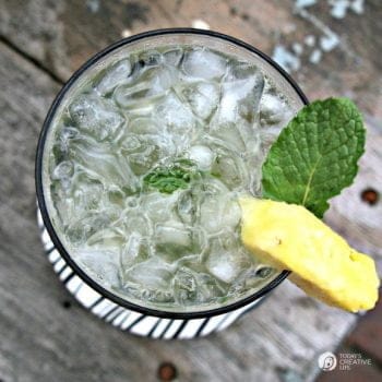 Looking down on a glass with ice and a cocktail.