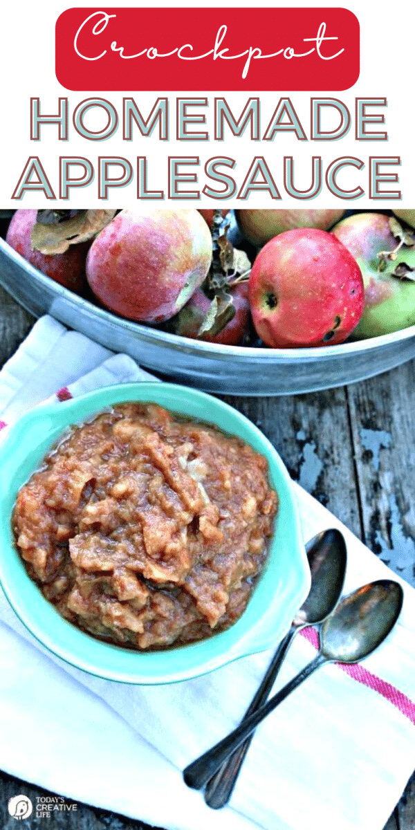 Slow Cooker Homemade Apple Sauce in a blue bowl. Large bowl of fresh picked apples next to applesauce.