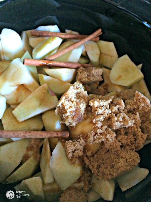 Cut up apples, cinnamon sticks and brown sugar in a crockpot.