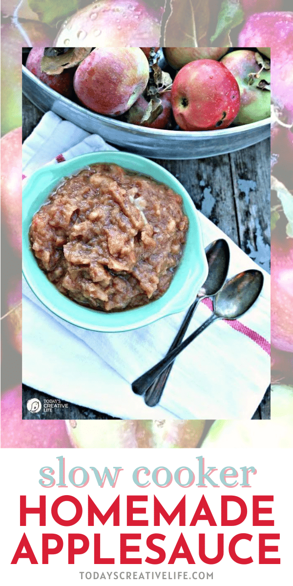 Homemade Applesauce in the Crockpot recipe. Applesauce in a blue bowl surrounded by another bowl of apples.