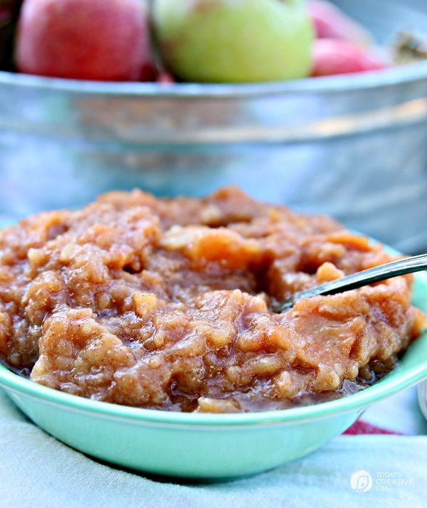 Homemade crockpot applesauce | Small bluish bowl filled with chunky applesauce.