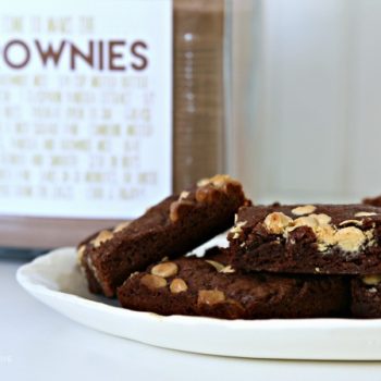 Brownies on a plate with a jar of brownie mix