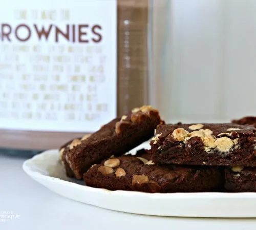 Brownies on a plate with a jar of brownie mix