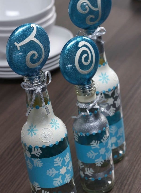 DIY Christmas Stenciled Bottle Craft by Amy Anderson | Bring on the glitter for this Easy DIY recycled bottle craft | See the full tutorial on TodaysCreativeLIfe.com