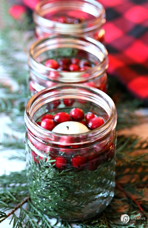 floating candles with cranberries and cedar for a stunning table centerpiece.