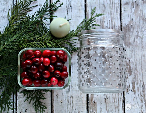 5 minute DIY Christmas luminaries Supplies: Jar, fresh cranberries, cedar greens, candle