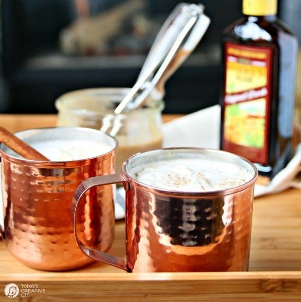 2 copper mugs filled with Hot Buttered Rum