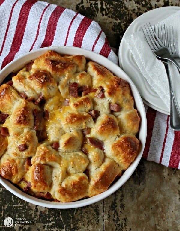 Breakfast Casserole Recipe made with Biscuits, egg, ham and cheese! This pull apart breakfast bread is easy to make and delicious to eat! Great for left over ham! See the recipe on TodaysCreativeLife.com