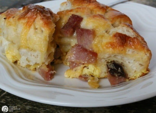 Breakfast Casserole Recipe made with Biscuits, egg, ham and cheese! This pull apart breakfast bread is easy to make and delicious to eat! Great for left over ham! See the recipe on TodaysCreativeLife.com