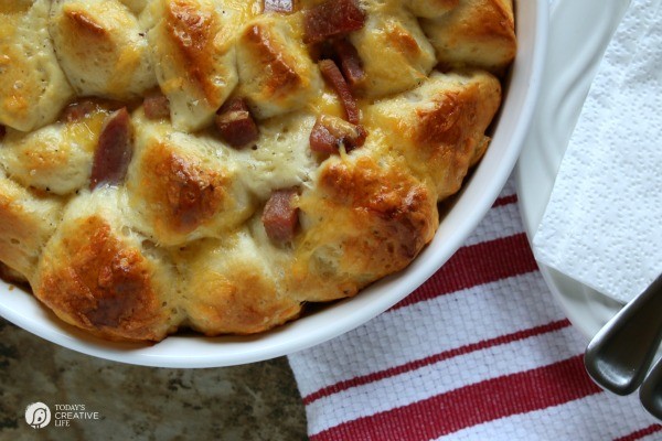 Breakfast Casserole Recipe made with Biscuits, egg, ham and cheese! This pull apart breakfast bread is easy to make and delicious to eat! Great for left over ham! See the recipe on TodaysCreativeLife.com