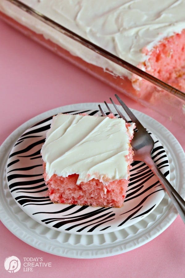 Strawberry Lemonade Cake | This is no ordinary cake, it's a strawberry lemonade poke cake that will delight your tastebuds! It's the perfect cake for spring time desserts. This doctored up cake box mix is the best short cut you'll ever take! Click the photo for the recipe! TodaysCreativeLife.com