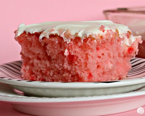 Strawberry Lemonade Cake | This is no ordinary cake, it's a strawberry lemonade poke cake that will delight your tastebuds! It's the perfect cake for spring time desserts. This doctored up cake box mix is the best short cut you'll ever take! Click the photo for the recipe! TodaysCreativeLife.com
