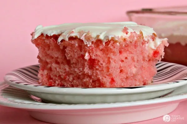 Strawberry Lemonade Cake | This is no ordinary cake, it's a strawberry lemonade poke cake that will delight your tastebuds! It's the perfect cake for spring time desserts. This doctored up cake box mix is the best short cut you'll ever take! Click the photo for the recipe! TodaysCreativeLife.com