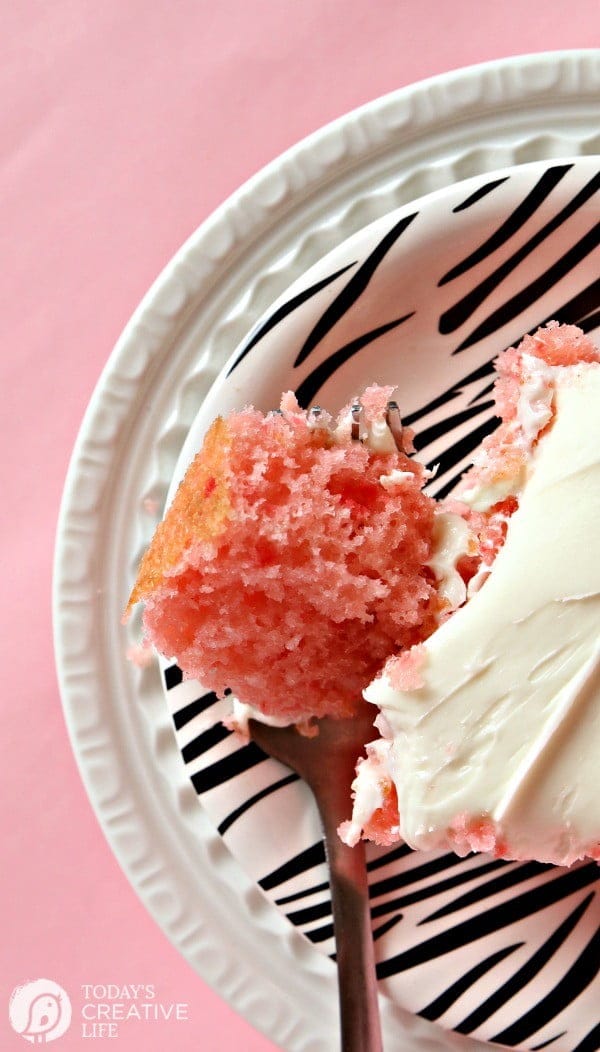 Strawberry Lemonade Cake | This is no ordinary cake, it's a strawberry lemonade poke cake that will delight your tastebuds! It's the perfect cake for spring time desserts. This doctored up cake box mix is the best short cut you'll ever take! Click the photo for the recipe! TodaysCreativeLife.com