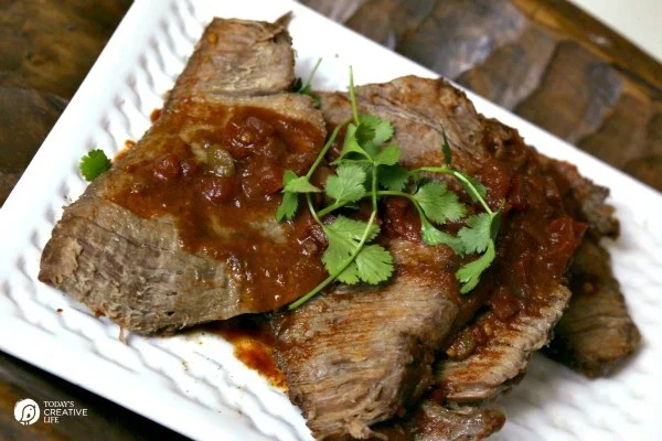 Slow Cooker Mexican Pot Roast | This crockpot pot roast is great shredded or sliced. Add more flavor for burritos, tacos, enchiladas or serve alone! Click on the photo for the recipe. 