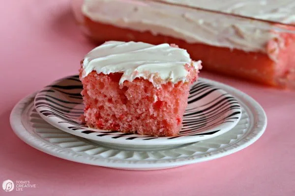 Strawberry Lemonade Cake | This is no ordinary cake, it's a strawberry lemonade poke cake that will delight your tastebuds! It's the perfect cake for spring time desserts. This doctored up cake box mix is the best short cut you'll ever take! Click the photo for the recipe! TodaysCreativeLife.com