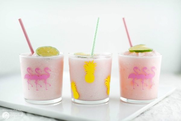 DIY Party Drinking Glasses - Flamingo & Pineapple | Create custom designs with your Cricut Explore, like these Flamingo and Pineapple party glasses. Quick and easy home and party ideas. See more on TodaysCreativeLife.com