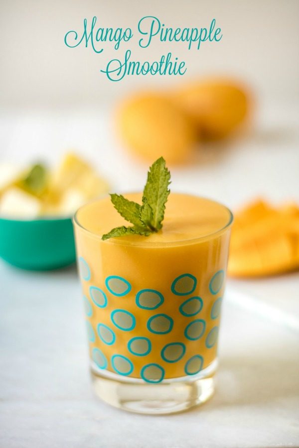 Mango Pineapple Smoothie in a decorative glass. Garnish with mint.