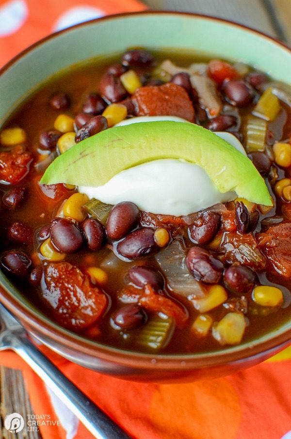 Slow Cooker Black Bean Soup | Beans, corn, tomatoes, celery, onion and more. Serve with sour cream and a slice of avocado. This satisfying crock pot soup is full of flavor and nutrition! A healthy choice for lunch or dinner! Click the photo for the recipe. TodaysCreativeLife.com