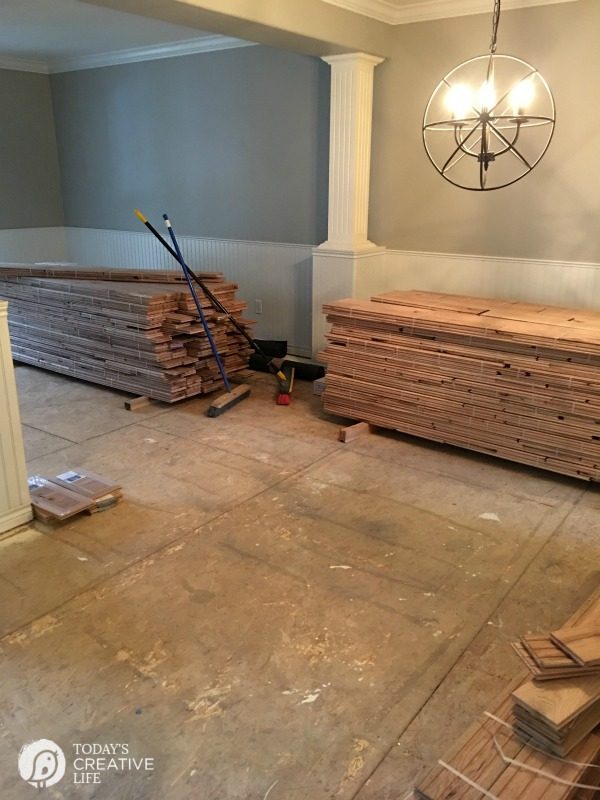 concrete sub-floor and stacks of new hardwood flooring