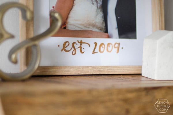 DIY Copper Foiled Photo Mat - What a perfect way to customize a standard photo frame! Hand lettered, foiled, and totally personal- this would make a great wedding gift! Love that it doesn't take a foiling machine