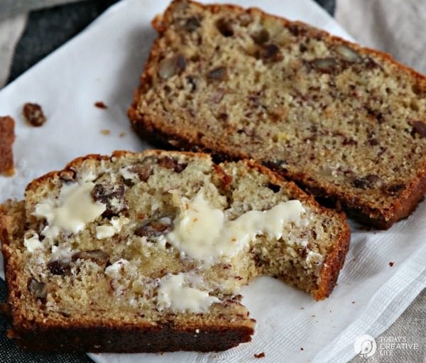 slice of buttered banana bread with a bite taken out