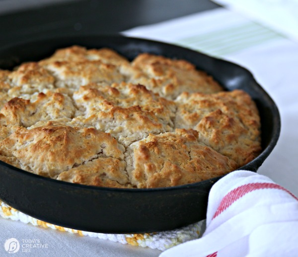 Cast iron skillet with golden brown biscuits. 