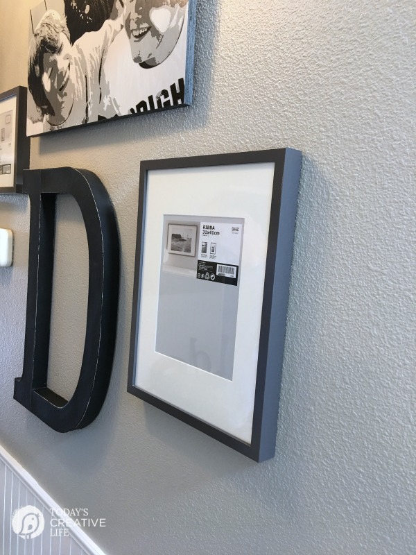 hanging pictures in a hallway