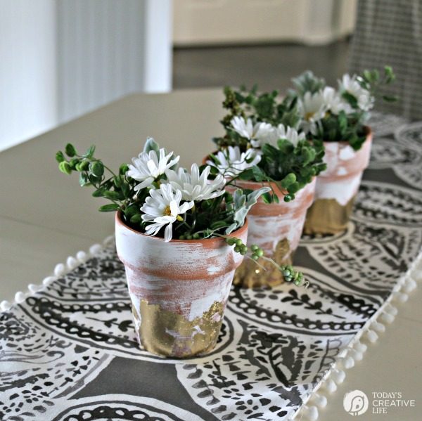 Table Centerpiece Ideas | How to use artificial greens and flowers for perfect everyday decorating for your home. Simple DIY & inexpensive. Easy to create this spring centerpiece in 10 minutes. See more on TodaysCreativeLife.com