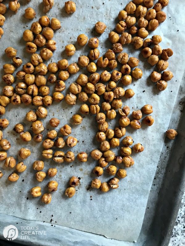 Roasted Chickpeas spread out on a baking pan after baking. 
