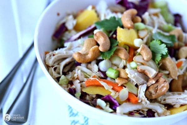 Cabbage, chicken, mango, green onion, carrots and cashew salad. 