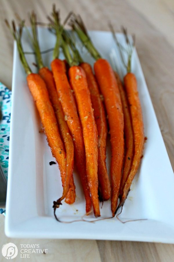 Honey Roasted Carrots with Garlic served on a white dish.